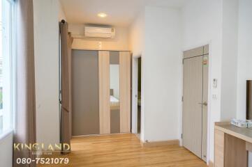 Spacious bedroom with modern sliding door wardrobe and air conditioning unit