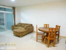 Living room with brown sectional sofa and dining table set