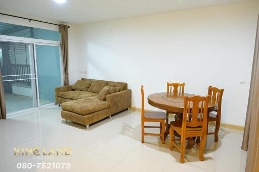 Living room with brown sectional sofa and dining table set