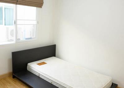 Minimalist bedroom with single mattress and window