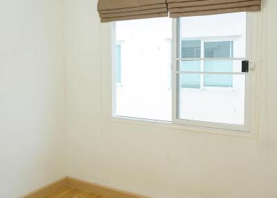 Bedroom with hardwood floors, a window, air conditioning, and blinds.