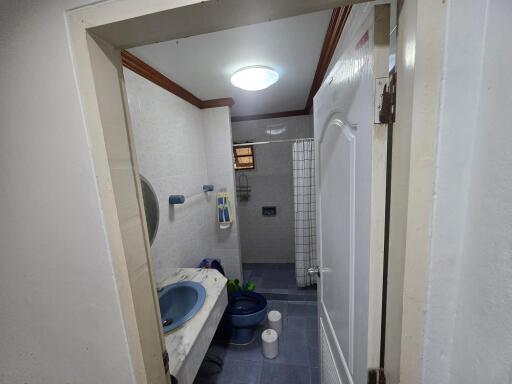 Modern bathroom with blue fixtures and tiled flooring