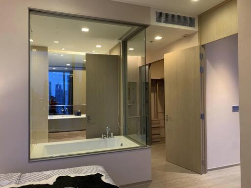 Modern bathroom with glass partition and bathtub