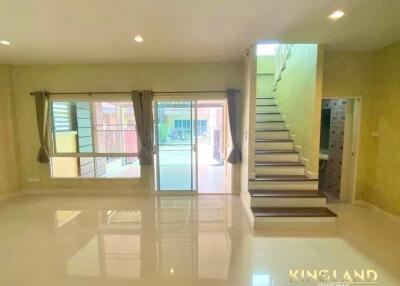 Spacious main living area with staircase and large glass doors