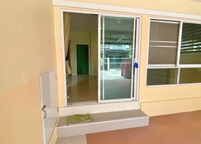 Exterior view of a residential property with glass sliding doors and a window