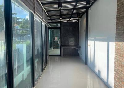 Modern glass-lined hallway with polished floors