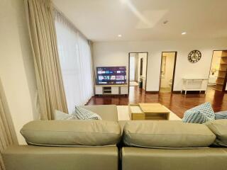 Modern living room with television and beige sofa