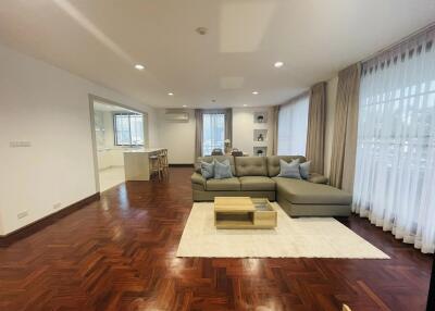 Spacious living room with a modern L-shaped sofa and wooden flooring