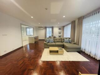 Spacious living room with a modern L-shaped sofa and wooden flooring