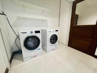 Laundry room with modern washing machine and dryer