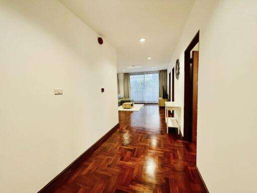 Spacious living room with wooden flooring and large window