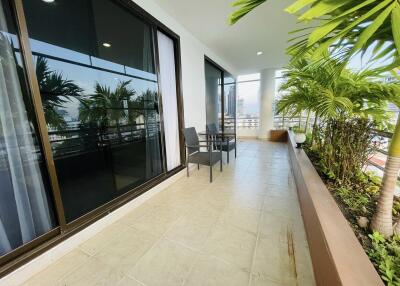 Spacious balcony with seating and potted plants