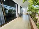 Spacious balcony with seating and potted plants