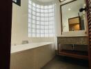 Modern bathroom with bathtub and glass block window