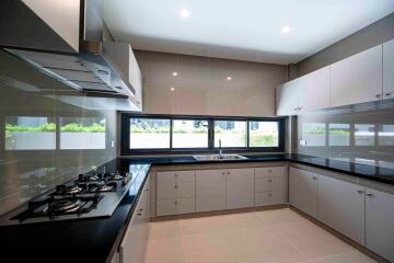 Modern kitchen with sleek cabinetry and large windows