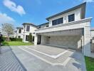 Front view of a modern luxury house with a spacious driveway