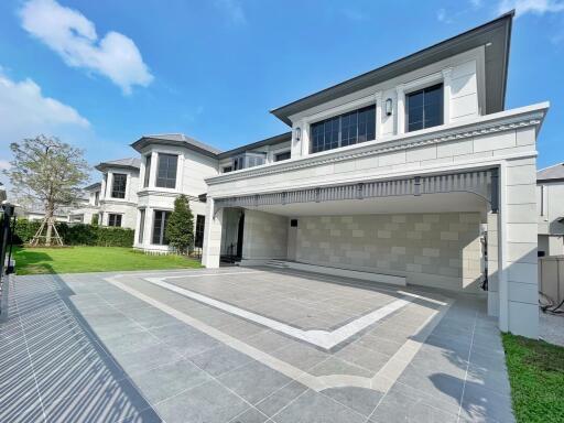 Front view of a modern luxury house with a spacious driveway