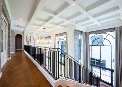 Elegant hallway with staircase and large windows