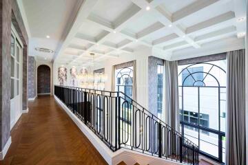 Elegant hallway with staircase and large windows