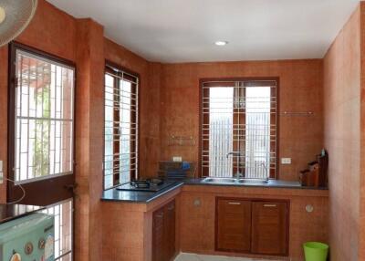 Modern kitchen with large windows and marble flooring