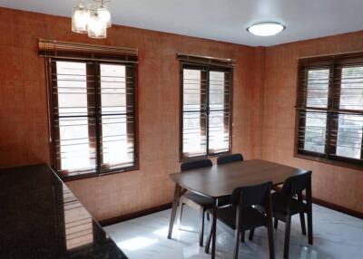 Dining area with large windows and wooden furniture