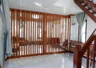 Living room with wooden partition and staircase