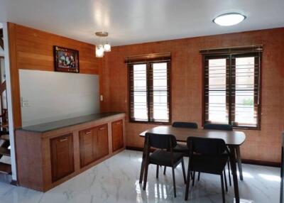 Dining area with table and chairs near large windows