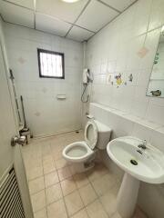 Bathroom with a white toilet and pedestal sink