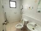 Bathroom with a white toilet and pedestal sink