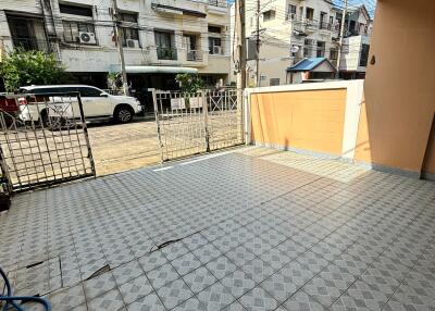 A tiled patio area with a view of neighboring houses