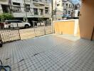 A tiled patio area with a view of neighboring houses