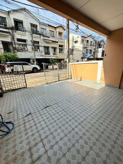 A tiled patio area with a view of neighboring houses