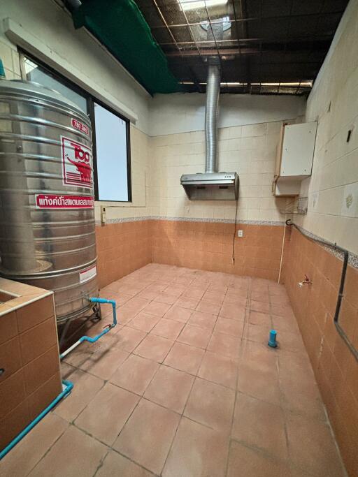 Kitchen with water heater and ventilation system