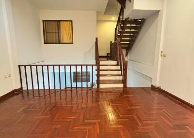 Spacious living room with wooden flooring and staircase