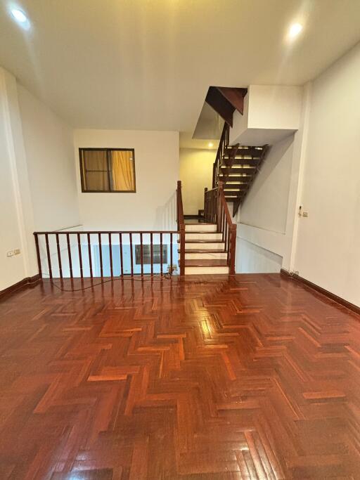 Living room with staircase and wooden flooring