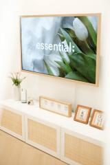 A well-decorated living room with a framed television and stylish cabinet