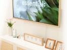 A well-decorated living room with a framed television and stylish cabinet