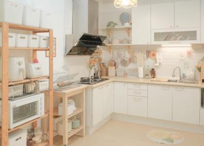 Well-organized kitchen with wooden shelves and white cabinets