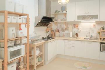 Well-organized kitchen with wooden shelves and white cabinets