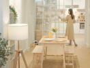 Bright dining area with a wooden table, benches, and a view into the modern kitchen