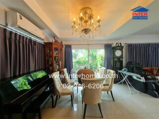 Elegant dining room with chandelier and large window