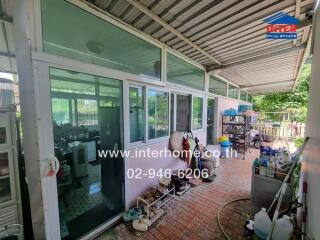 outdoor area with glass windows and a covered walkway