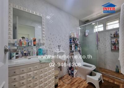 Bathroom with vanity, sink, mirror, shower, and toilet