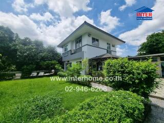 Two-story house with a lush garden