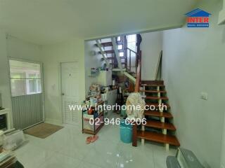 Hallway with staircase and storage area