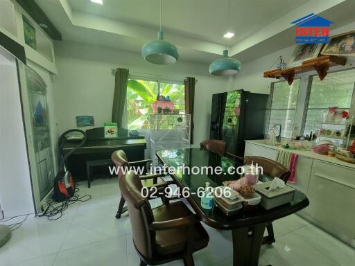 Dining room with table, chairs, and large windows