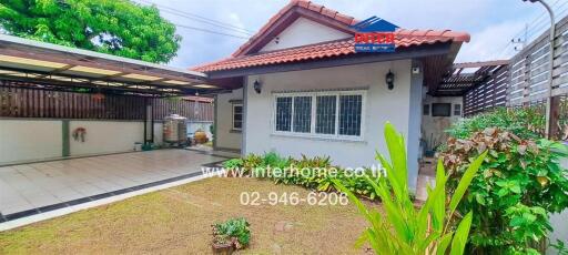 Exterior view of a house with a yard and carport