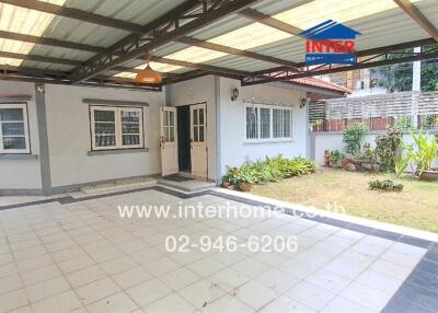 Covered outdoor area with garden and building view