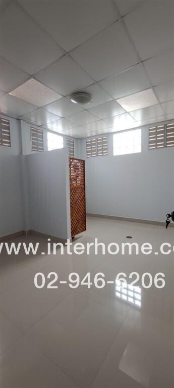 Interior view of an empty room with light walls and tiled floors