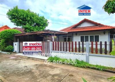 Exterior view of a house for sale with a front yard and fence